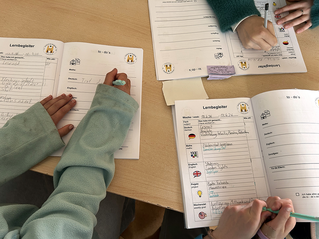 Schüler*innen einer Lerngruppe 4–6 dokumentieren ihre Lerninhalte im Lernbegleiter.